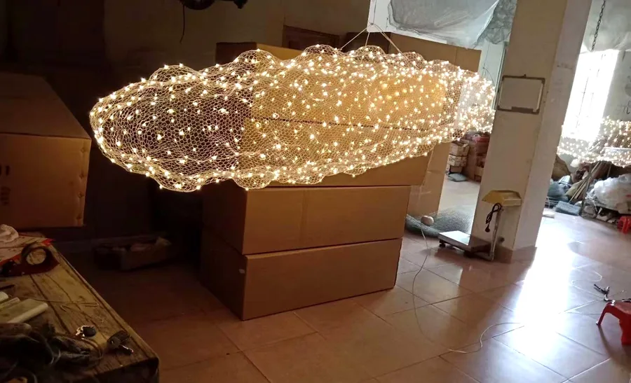 Custom cloud-shaped LED mesh chandelier on lit test in our workshop