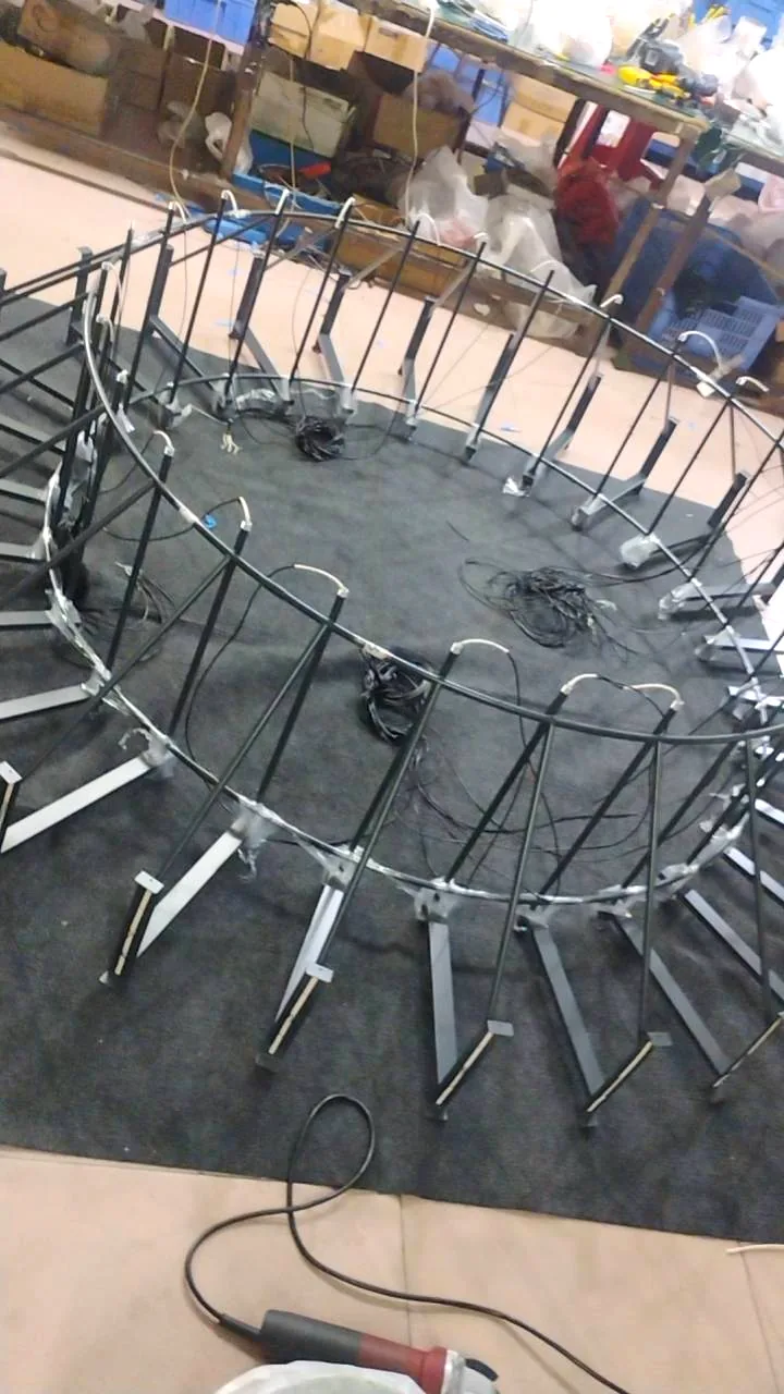 Large round chandelier frame jigged for assembly in the workshop