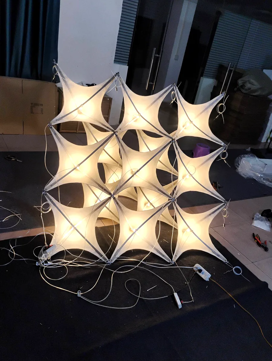 Custom stretch-fabric module fixture on lit test in the workshop
